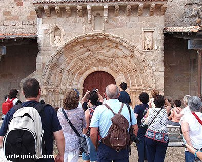 Frente a la monumental puerta sur de Santa María del Rey